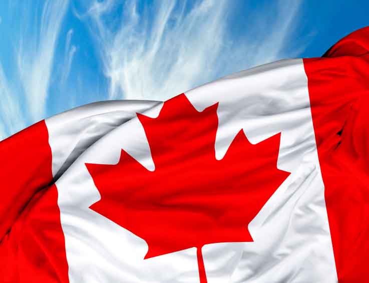 Canada flag waving against sky Canada flag waving against sky