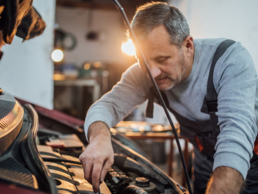 Car mechanic working on an engine