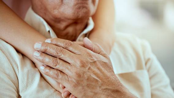 Elderly man with hands on his chest