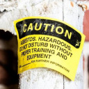 Yellow asbestos caution sign on insulated pipe