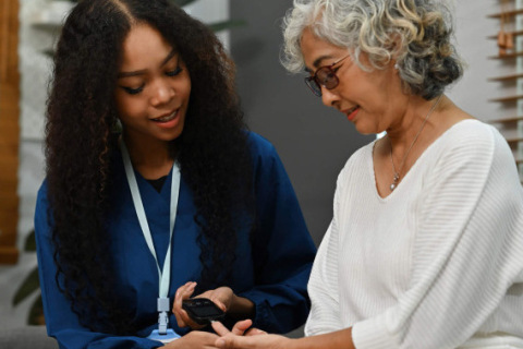 A doctor helps a mesothelioma patient with diabetes check their blood sugar