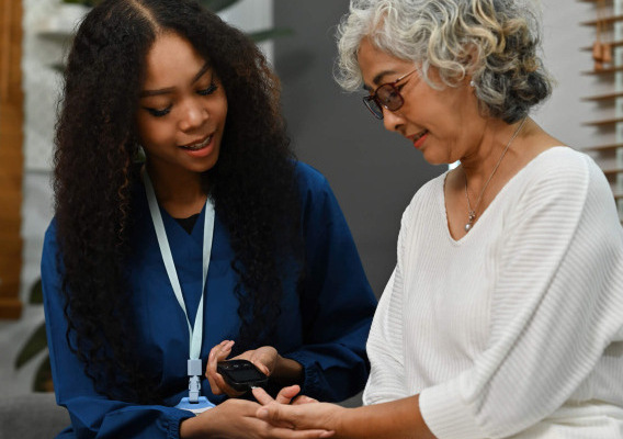 A doctor helps a mesothelioma patient with diabetes check their blood sugar