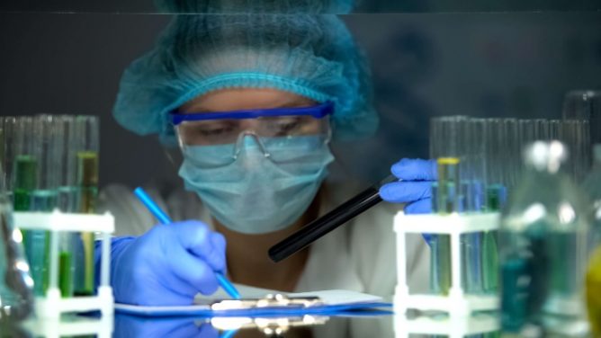 Doctor examining test tubes