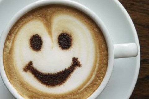 Cup of Coffee with a Happy Face in the Foam