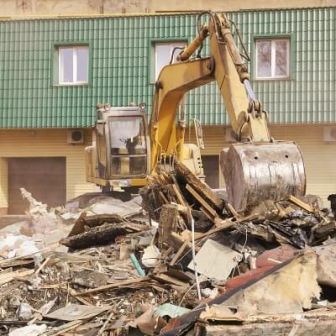 Backhoe clearing asbestos debris