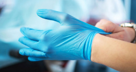 Image of a person putting on gloves
