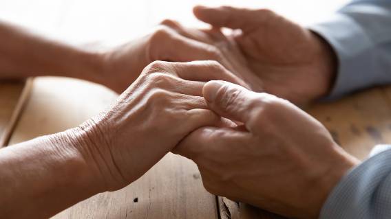 Close-up of couple man and woman holding hands