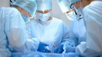 Four surgeons performing surgery