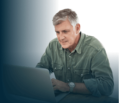 Older man viewing webinar on a laptop