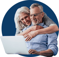 Senior couple at home with laptop