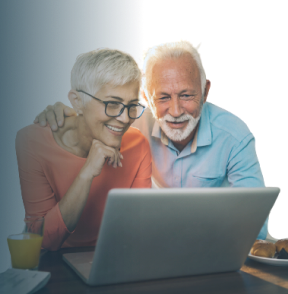 Elderly man and woman watching a webinar on a laptop