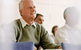 Older man listening in a support group