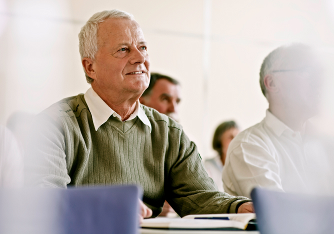 Older man listening in a support group