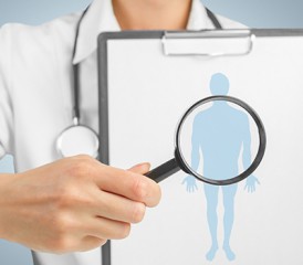 Doctor Putting a Magnifying Glass over a Body Diagram Doctor Putting a Magnifying Glass over a Body Diagram