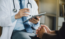 Doctor reviews patients notes during medical appointment