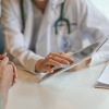 Doctor with female patient and tablet
