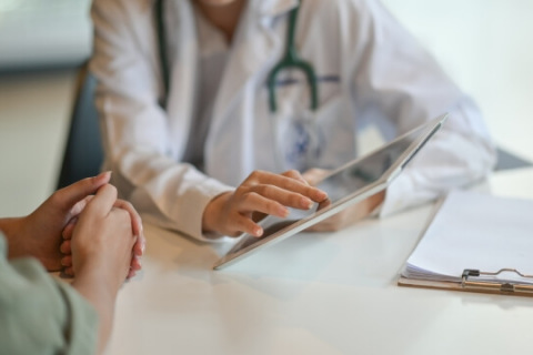 Doctor with female patient and tablet