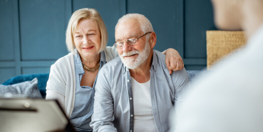 Elderly couple talking to financial advisor
