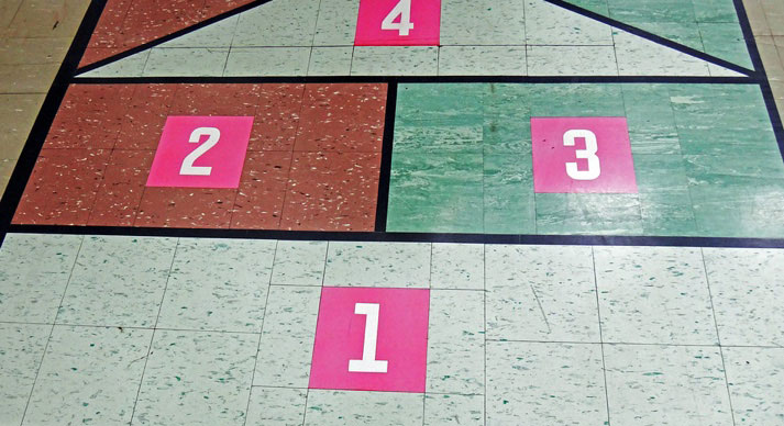 Asbestos-containing floor tile being used as a hopscotch game in an elementary school.