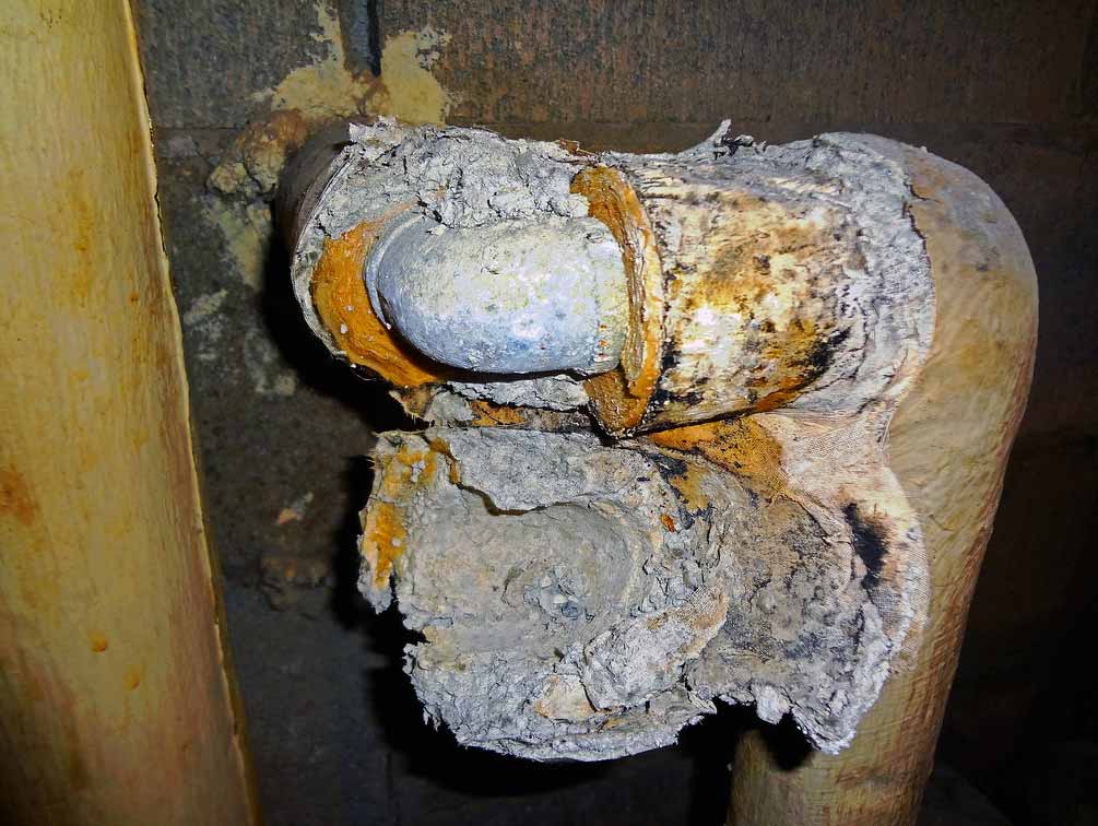 Deteriorated pipe insulation containing friable asbestos