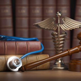 Gavel with stethoscope on legal books