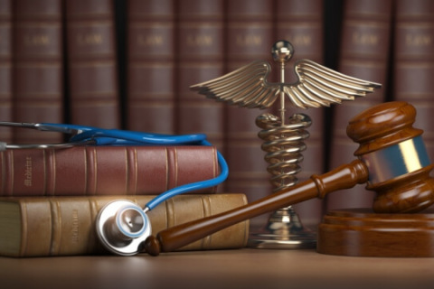 Gavel with stethoscope on legal books