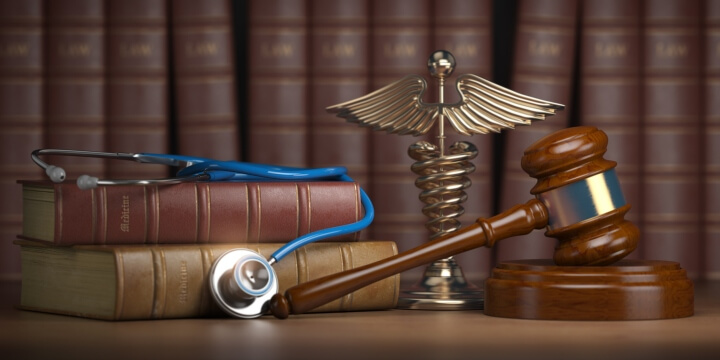 Gavel with stethoscope on legal books