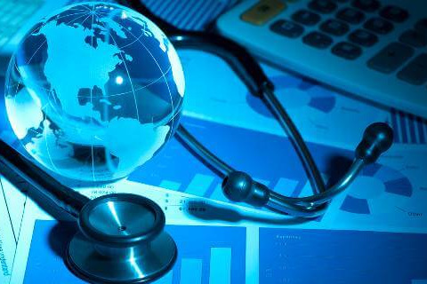 Globe and stethoscope on charts