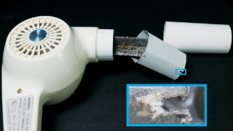 Asbestos paper insulation inside a hair dryer handle