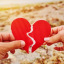Hands holding a broken heart