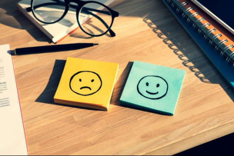 Post-its with happy and sad faces