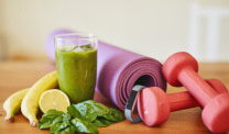 Smoothie, spinach yoga mat and dumbbells