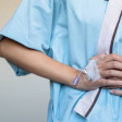 Patient holding stomach after surgery