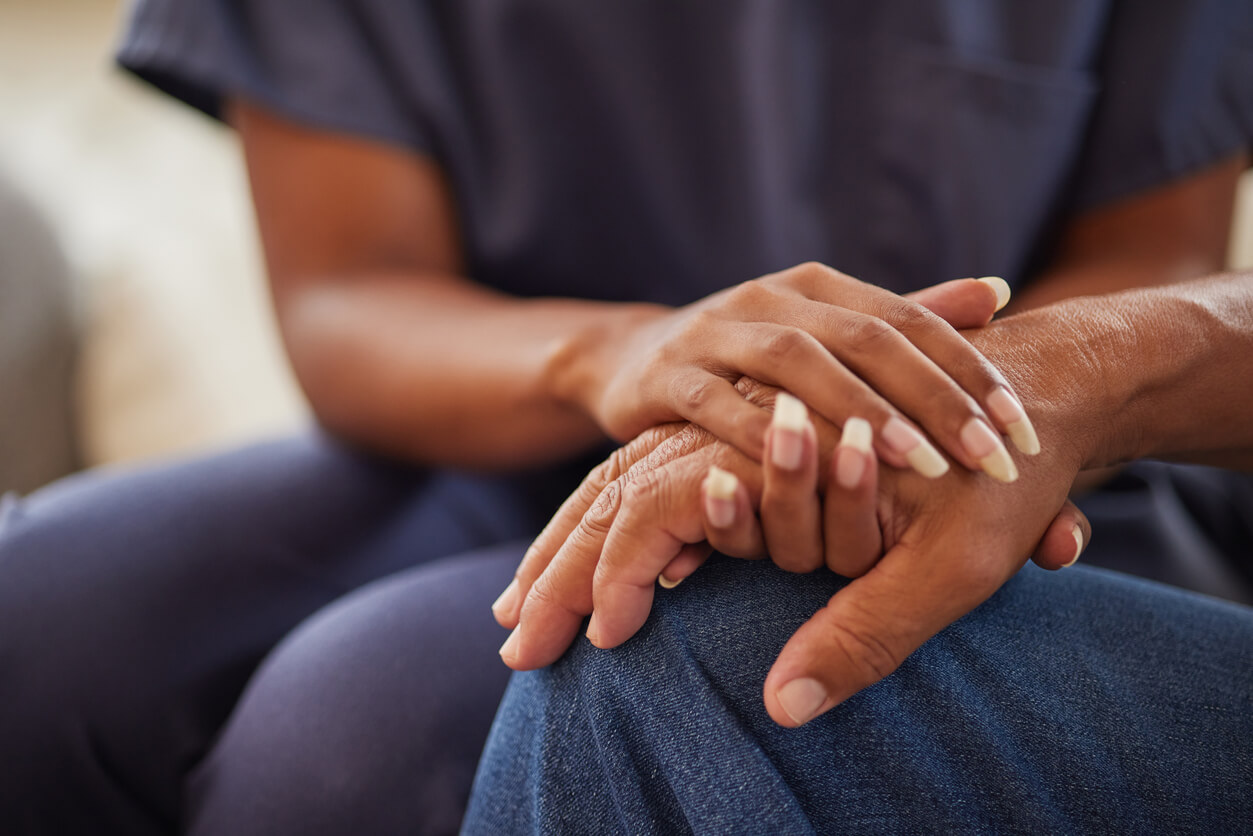 doctor and patient holding hands