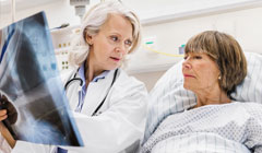 Woman in hospital bed with doctor