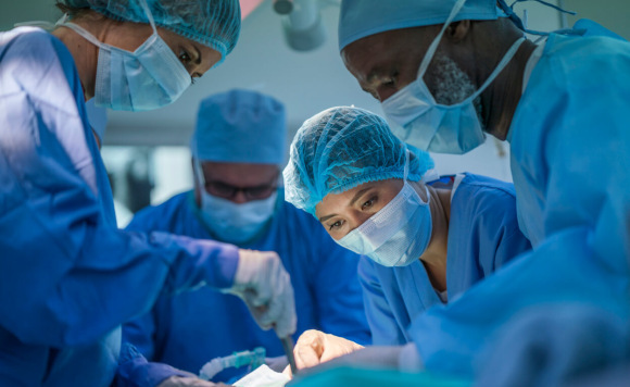 Surgical oncologists performing an operation