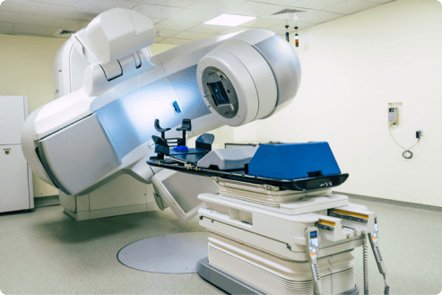 Photograph of a room-sized medical scanner with patient table delivering image-guided radiation therapy.
