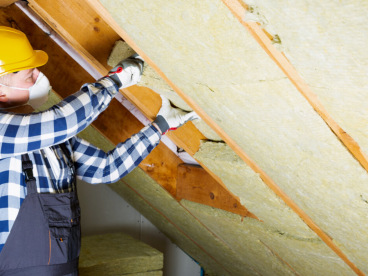 Worker installing insulation
