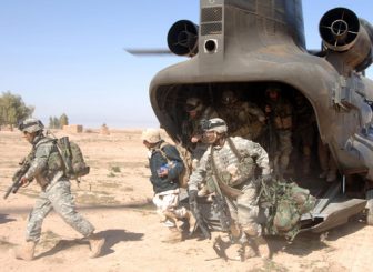 U.S. Soldiers running out of a CH-47 Chinook helicopter during the Iraq war.