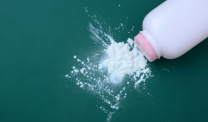 Pink baby powder bottle spilling talc