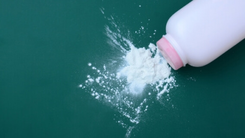 Pink baby powder bottle spilling talc