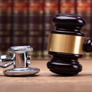 Stethoscope and gavel with law books