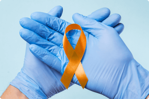 doctors hands holding leukemia support ribbon
