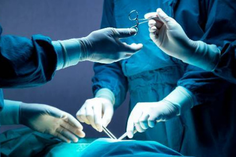 Surgeons in blue with medical instruments