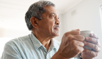 man drinking coffee at home