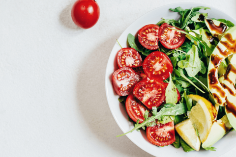 Bowl of tomatoes, spinach and avocados