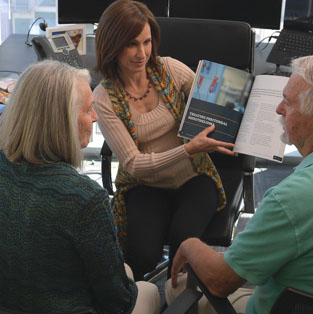 Information about mesothelioma being explained to an older couple by Karen Selby, Registered Nurse and Patient Advocate for the Mesothelioma Center.