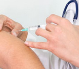 Doctor injecting patient