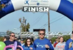 Group of people running the Miles for Meso race