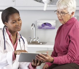 Doctor showing patient information on iPad